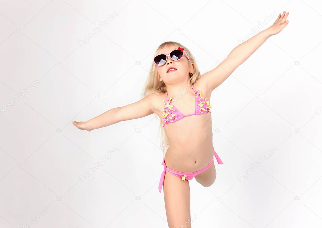 Beautiful teen girl dancing dressed in swimsuit,