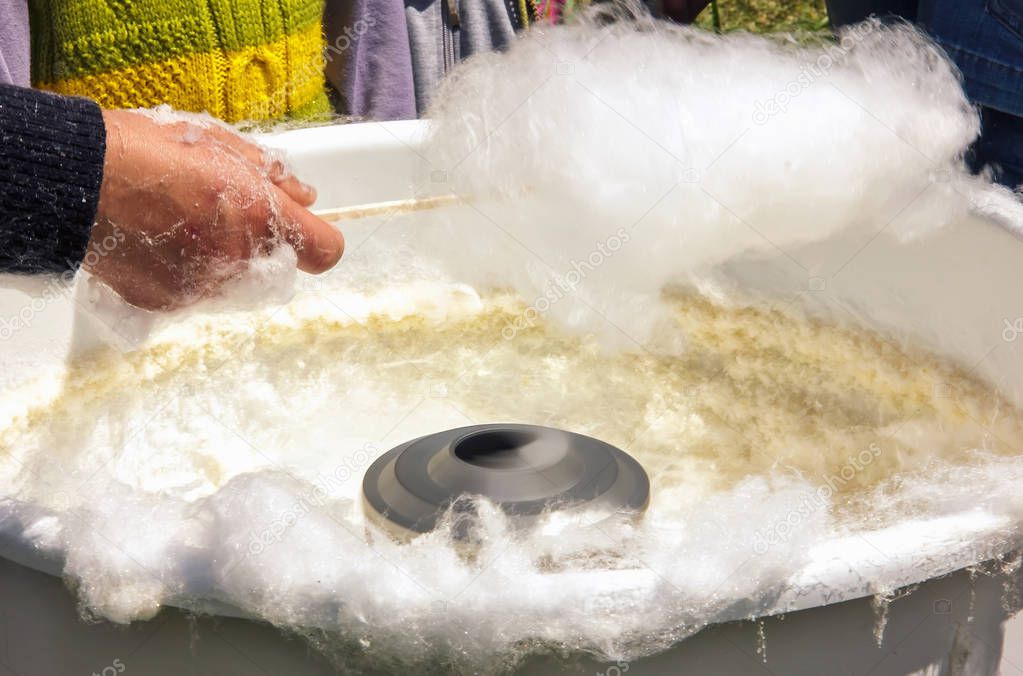 Process of cooking cotton candy in a candy machine,