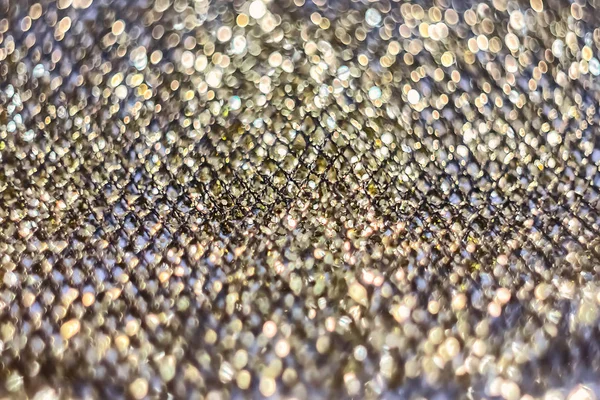 texture of golden shiny fabric mesh, for design and creativity, on a gray background