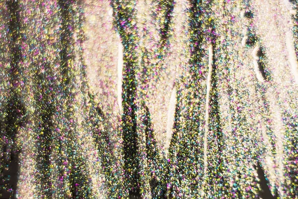Gold and pink glitter on a black background as a background. Abs