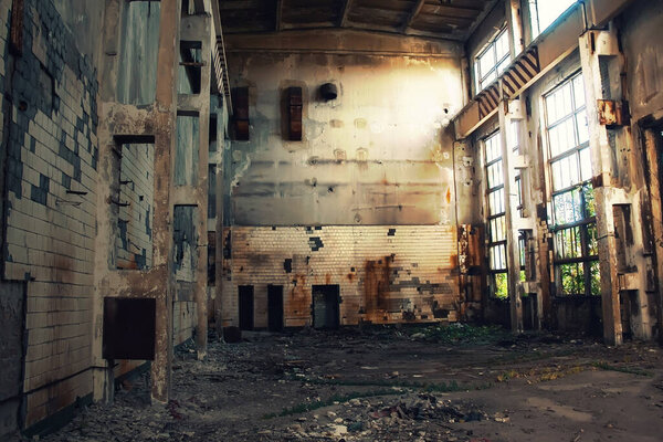 Large abandoned industrial hall. Dangerous area. Abandoned industrial interior with bright lights. Exclusion zone, radiation risk, lost city, apocalyptic building
