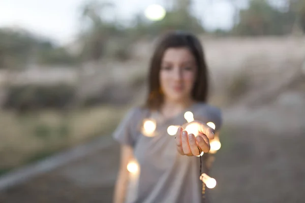 Adolescente com luzes focadas nas mãos . — Fotografia de Stock