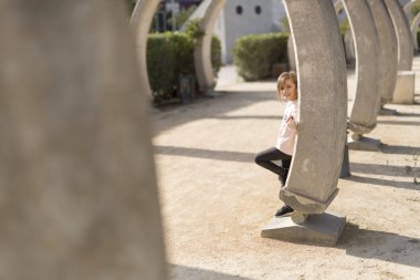 Taştan bir duvar arkasındaki kız.