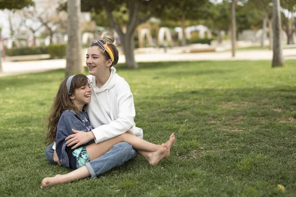 Meninas felizes sentadas na grama . — Fotografia de Stock