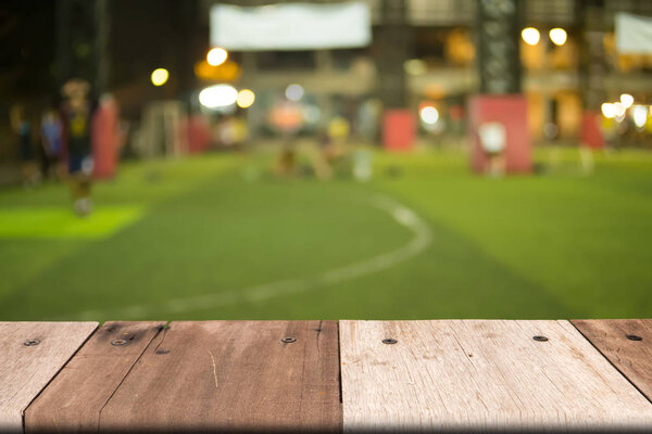 Empty wooden table of brown on front blurred grass background
