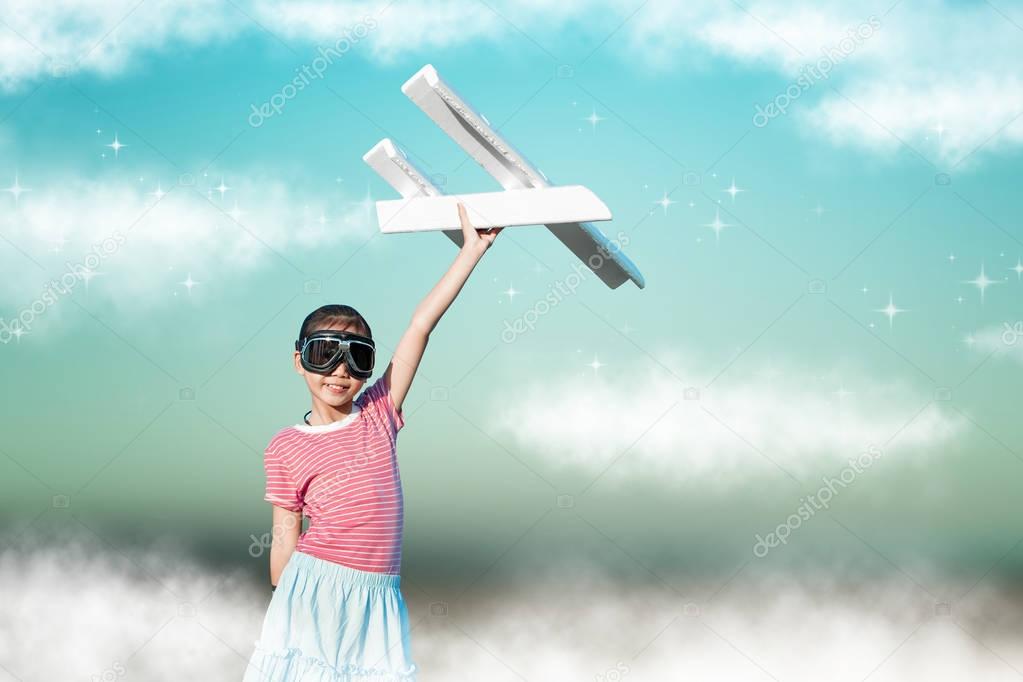 Cute asian girl playing toy plane as pilot imagination to the fu