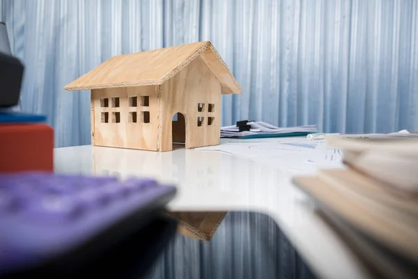 Business desk close up with house wood model. — Stock Photo, Image