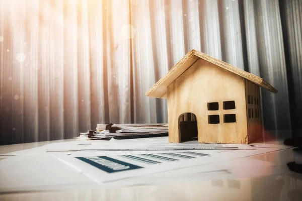 Casa e propriedade para venda conceito, brinquedo de casa de madeira no escritório de — Fotografia de Stock