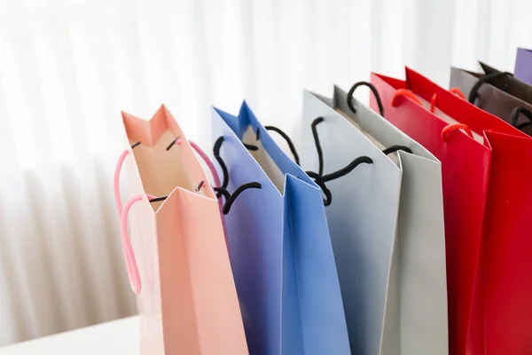 白い部屋のスタジオブラインドの背景で女性のショッピングのためのカラフルなショッピングバッグ — ストック写真