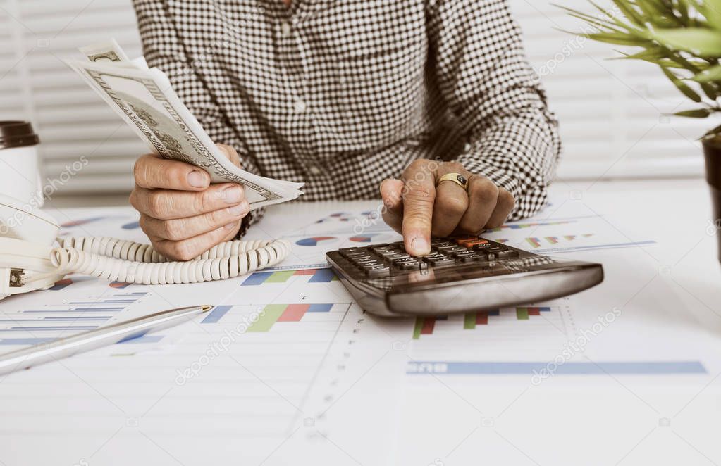 Business owner calculating daily income.