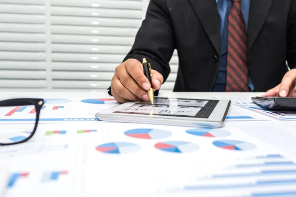 Bankers are recording financial information and balance sheet of the company to analyze the loan approval.