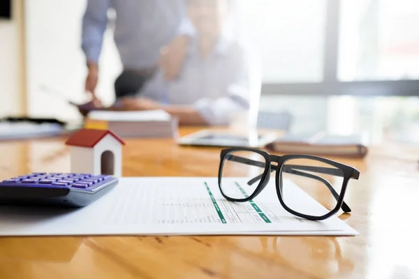 Business man working desk with financial paperwork data about loan agreement with financial institution To buy real estate that is sold by public auction