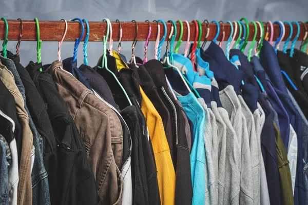 Clothes rack clothes were hanging by a variety of colors for men older Asians.