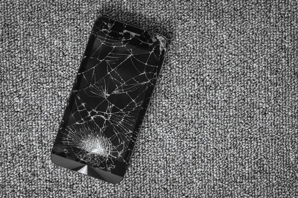 Cracked screen of smartphone mobile black glasses top view photography.