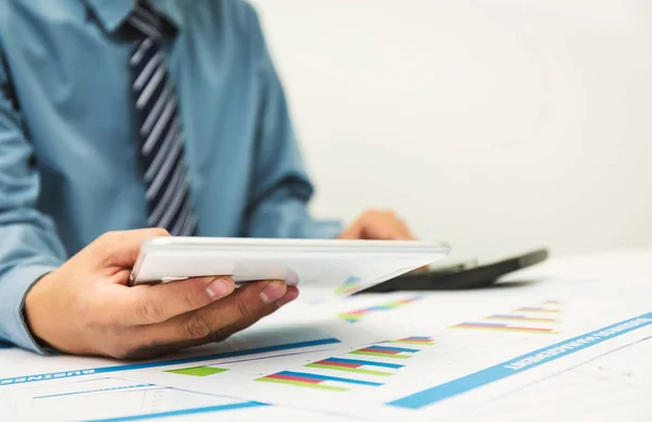 Businessman using a personal income tax calculator. — Stock Photo, Image