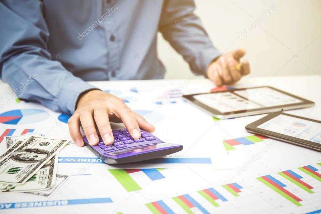 Businessman using a personal income tax calculator.