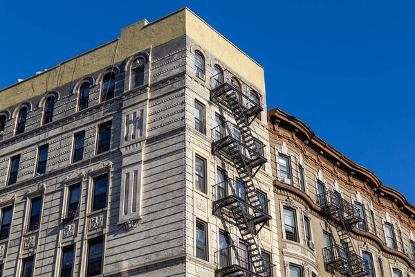 New York, United States of America - November 19, 2016: Residential Buildings with typical fire escapes in Manhatten.