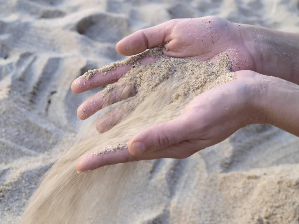 Sand falling from hands Royalty Free Stock Images