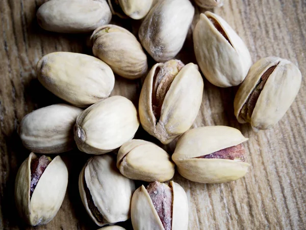 Group of pistachios on wood background — Stock Photo, Image