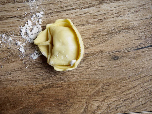 Tortellini on wood background — Stock Photo, Image