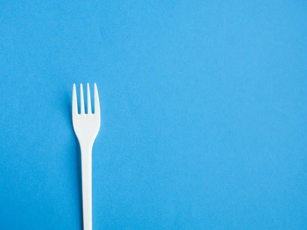 Plastic fork pattern on blue background — Stock Photo, Image