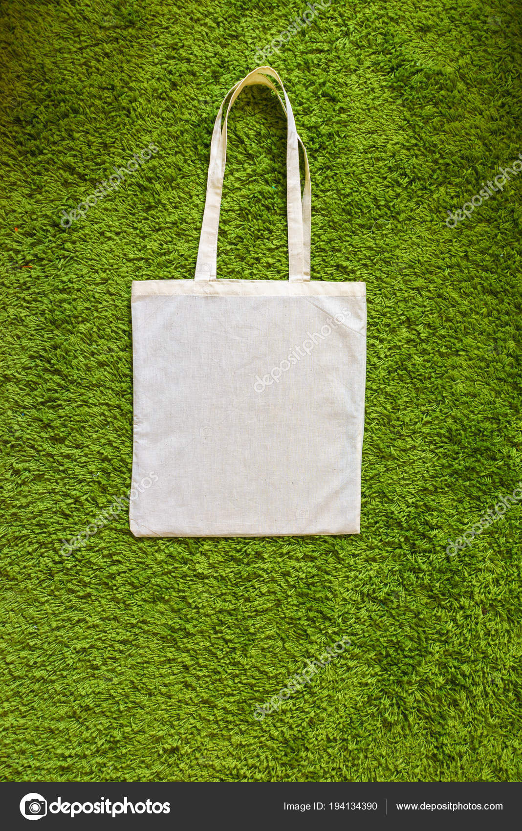 Download Eco bag made of unpainted 100 cotton on a green artificial ...