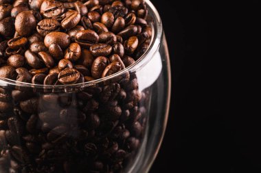 a big jar full of coffee beans, isolated on black with clipping path.