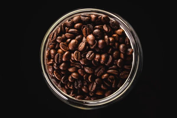 A big jar full of coffee beans, isolated on black with clipping path. — Stock Photo, Image