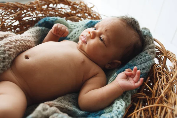African newborn kid lying in wicker cradle — Stock Photo, Image