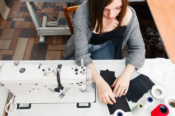 Швея, работающая на швейной машинке вид сверху — стоковое фото