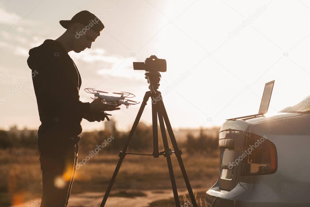 Professional photographer work outdoor at sunset