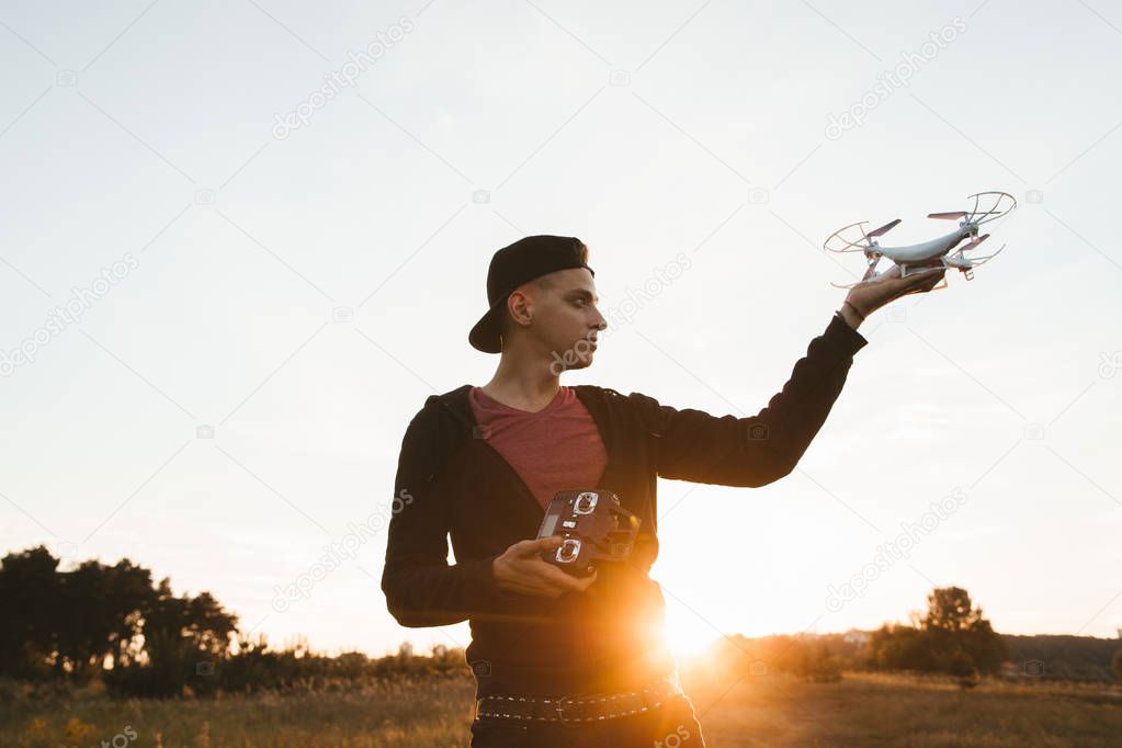 Profile of man holding drone outdoor, free space