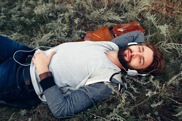 Gars détendu dormir en plein air dans les écouteurs — Photo