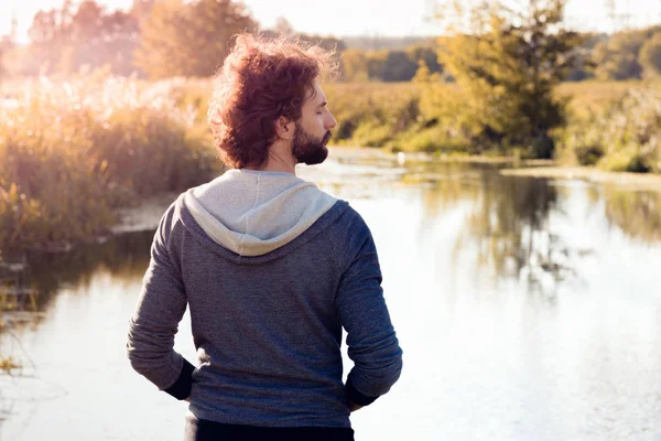 Back of man looking at river, free space — Stock Photo, Image