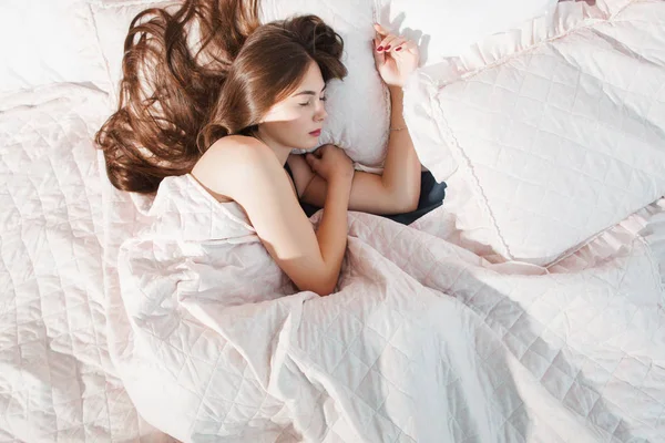 Lonely girl sleeping in bed top view flat lay — Stock Photo, Image