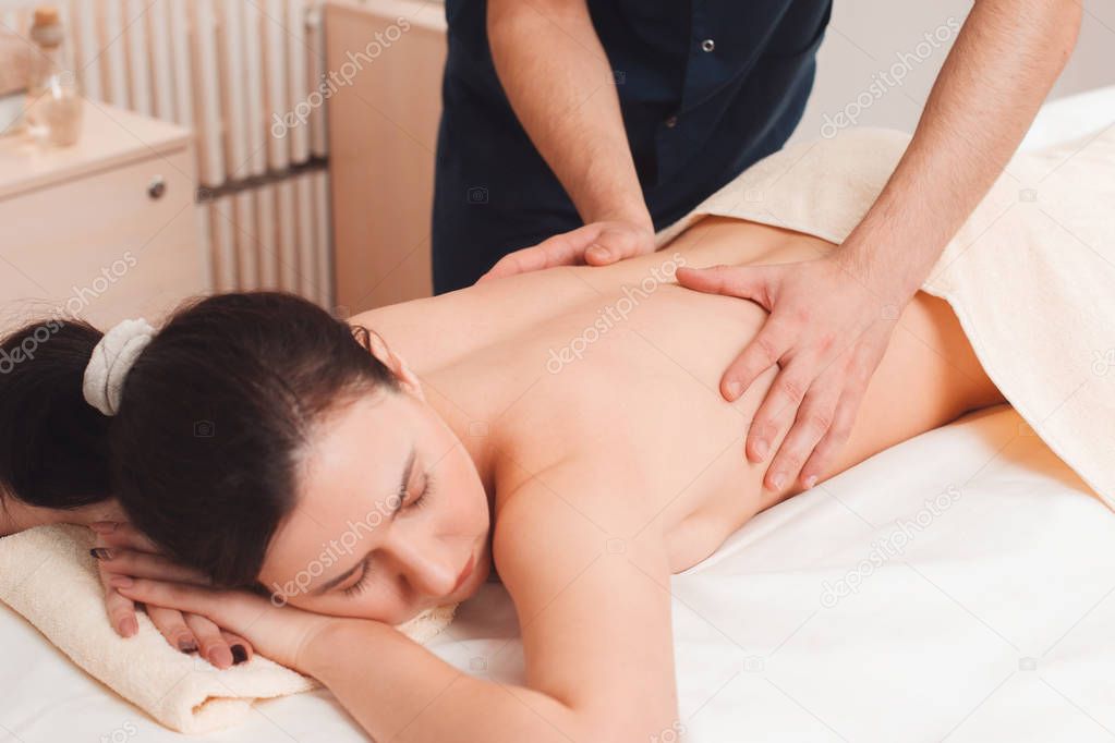 Young woman at massage procedures free space
