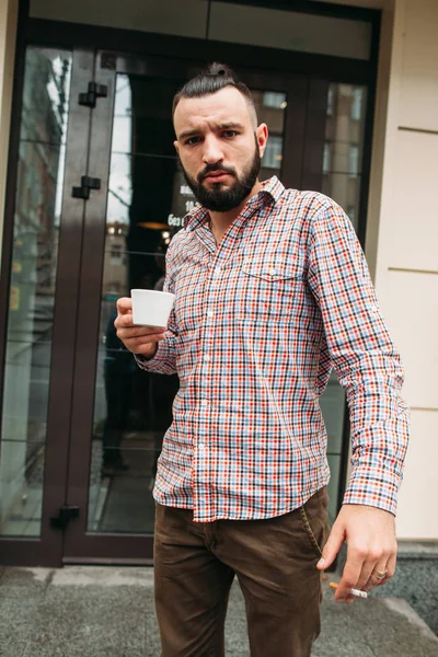 Young man having smoko outdoor free space