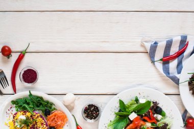 Salata çerçeve düz beyaz tahta masada yattı