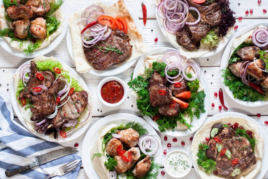 Assortment of grilled meat meals flat lay