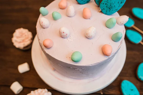Beyaz ahşap masa üzerinde bisküvi kek dekore edilmiştir. — Stok fotoğraf