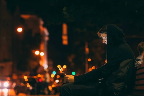 Hooded man chatting with laptop in night — Stock Photo, Image