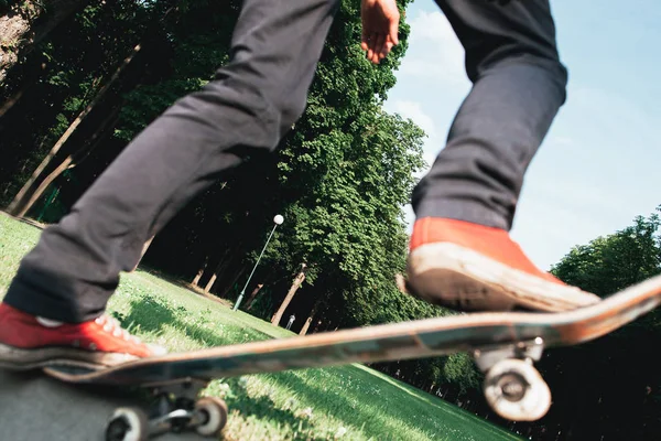 Skateboarder make back slide trick on park