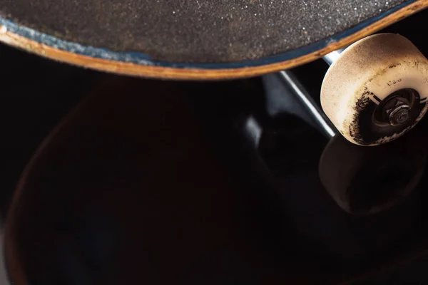 Skateboard deck and wheel on glance background