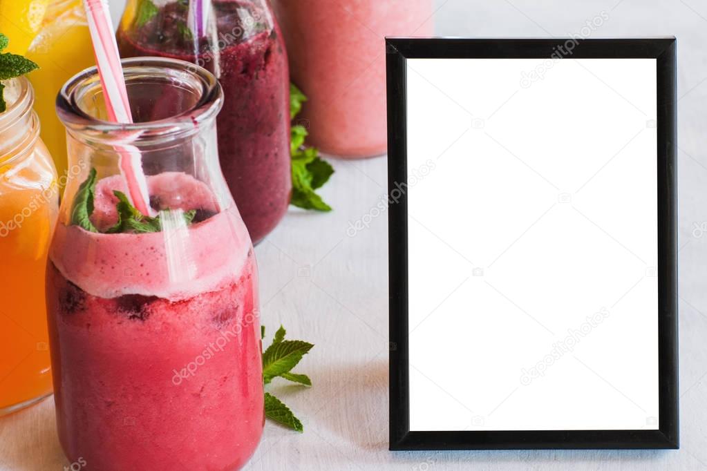 Picture frame with fresh fruit smoothies nearby