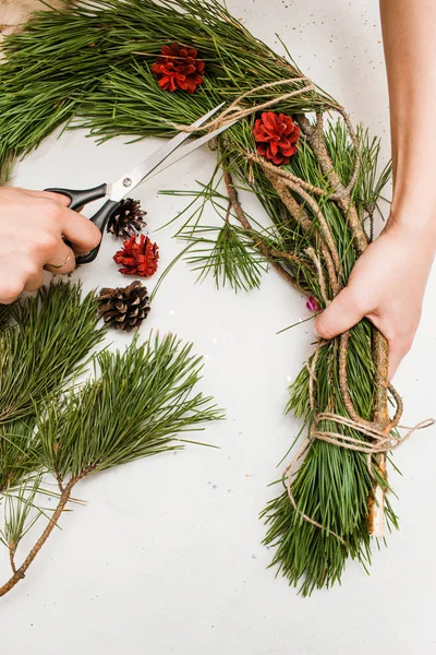 Christmas wreath making by woman