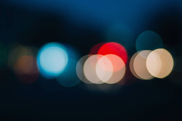 Bokeh blurring urban colours concept. Abstract background. Defocused lights. Shiny spots.