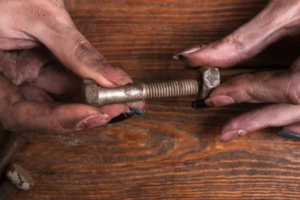Female dirty hands screw nut bolt modern job — Stock Photo, Image