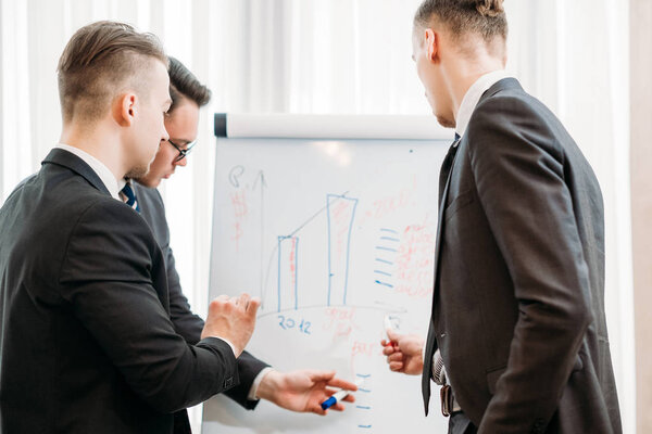 teamwork cooperation business men discuss graph