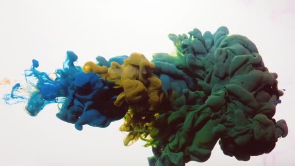 Paint drops mixing water blue yellow smoke cloud — Stock Video