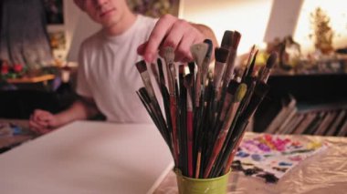 art hobby man choosing brush painting new picture
